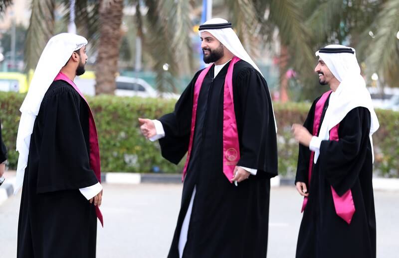 Hussain Jaffar, Fares Ali and Waleed Hussain chat before the drive-through graduation ceremony at Ajman University.