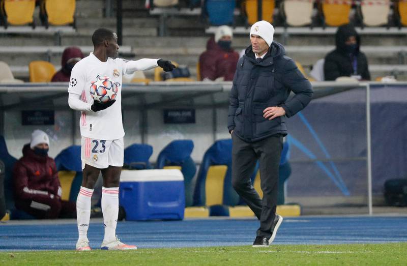Zinedine Zidane and Real Madrid defender Ferland Mendy talk on the touchline. Reuters