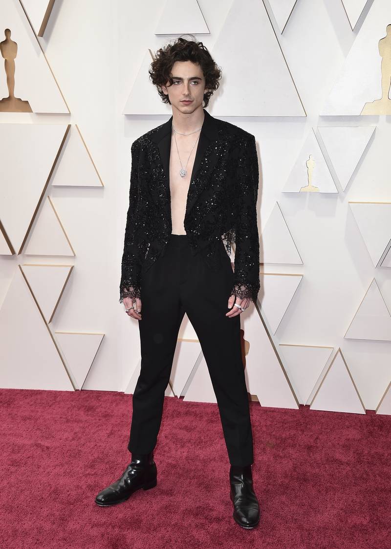 Timothee Chalamet, in a lace cropped blazer by Louis Vuitton, arrives at the Oscars on Sunday, March 27, 2022. AFP
