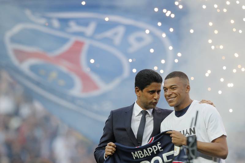 PSG President Nasser Al-Khelaifi speaks to Kylian Mbappe as they announce the France forward has signed a new deal. AP