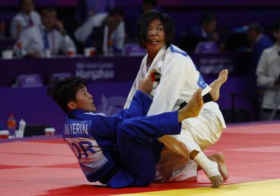 UAE judoka Bishrelt Khorloodoi, right, impressed in women's 52kg division at the 2023 Asian Games in Hangzhou. Reuters