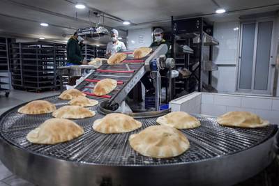 Flat bread loaves on a conveyor inside the kitchen at a local bakery in Beirut, Lebanon on June 27. Hasan Shaaban/Bloomberg
