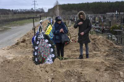 Natalya Verbova, 49, and her son attend the funeral of her husband Andriy Verbovyi, 55, who was killed by Russian soldiers while defending Bucha on the outskirts of Kyiv. AP