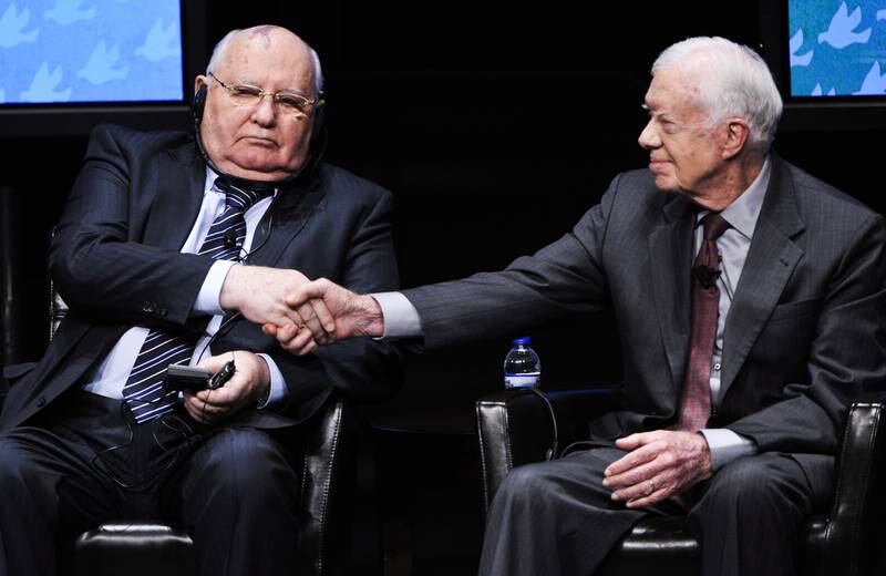 Former US President Jimmy Carter shakes hands with Gorbachev during the 12th World Summit of Nobel Peace Laureates in Chicago, Illinois, in April 2012. EPA