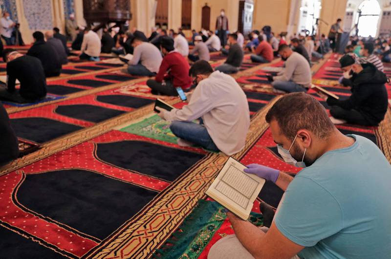 Worshippers gather for the Friday prayers during the Muslim holy month of Ramadan, while keeping a safe distance from each other, at the Mohammed Al-Amin Mosque in the Lebanese capital Beirut's downtown district, after some measures that were taken by the authorities in a bid to prevent the spread of the novel coronavirus were eased, on May 8, 2020. (Photo by ANWAR AMRO / AFP)