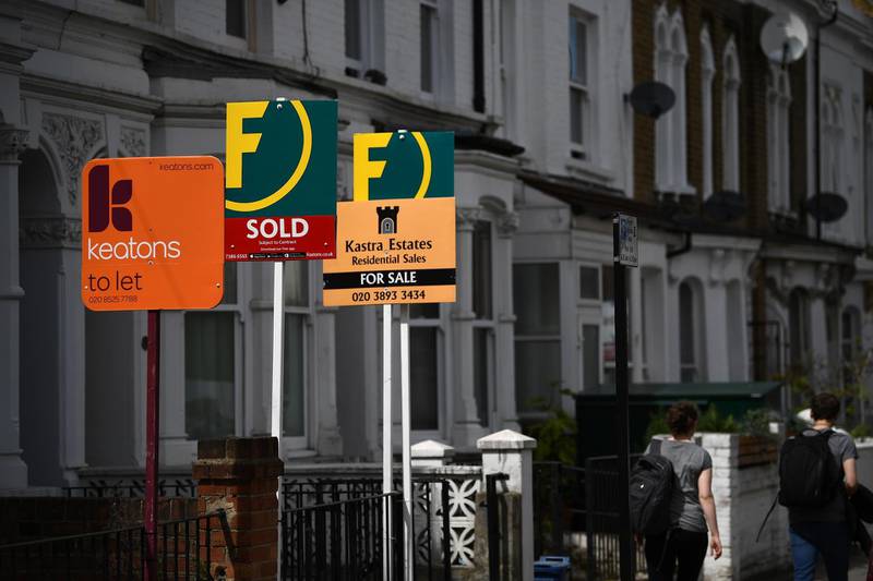Estate and rental agents' boards are pictured on a residential street in Hackney, east London on August 9, 2019. House prices and sales are "losing momentum", surveyors say, although parts of the UK are still seeing property values rise.
 / AFP / Daniel LEAL-OLIVAS

