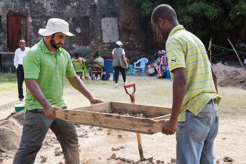 An archaeologist with Abu Dhabi's Tourism and Culture Authority, Omar Al Kaabi sieves for finds with a local member of the excavation team in Stone Town, Zanzibar.