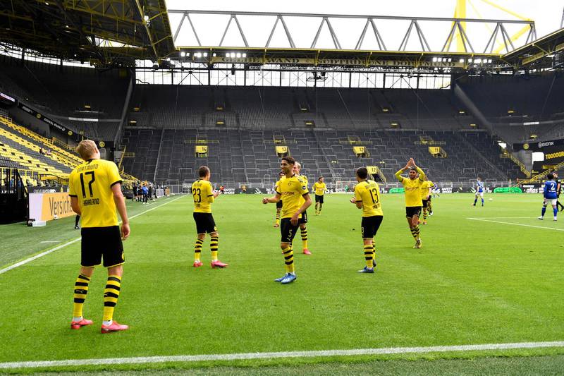 Dortmund's Erling Haaland, left, celebrates after scoring the opening goal. AP