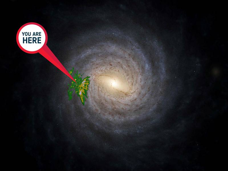An artistic impression of the Milky Way released by the European Space Agency, with an overlay showing the location and densities of a young star sample from Gaia’s data release 3 (in yellow-green).  The “you are here” sign points towards the Sun.  AFP