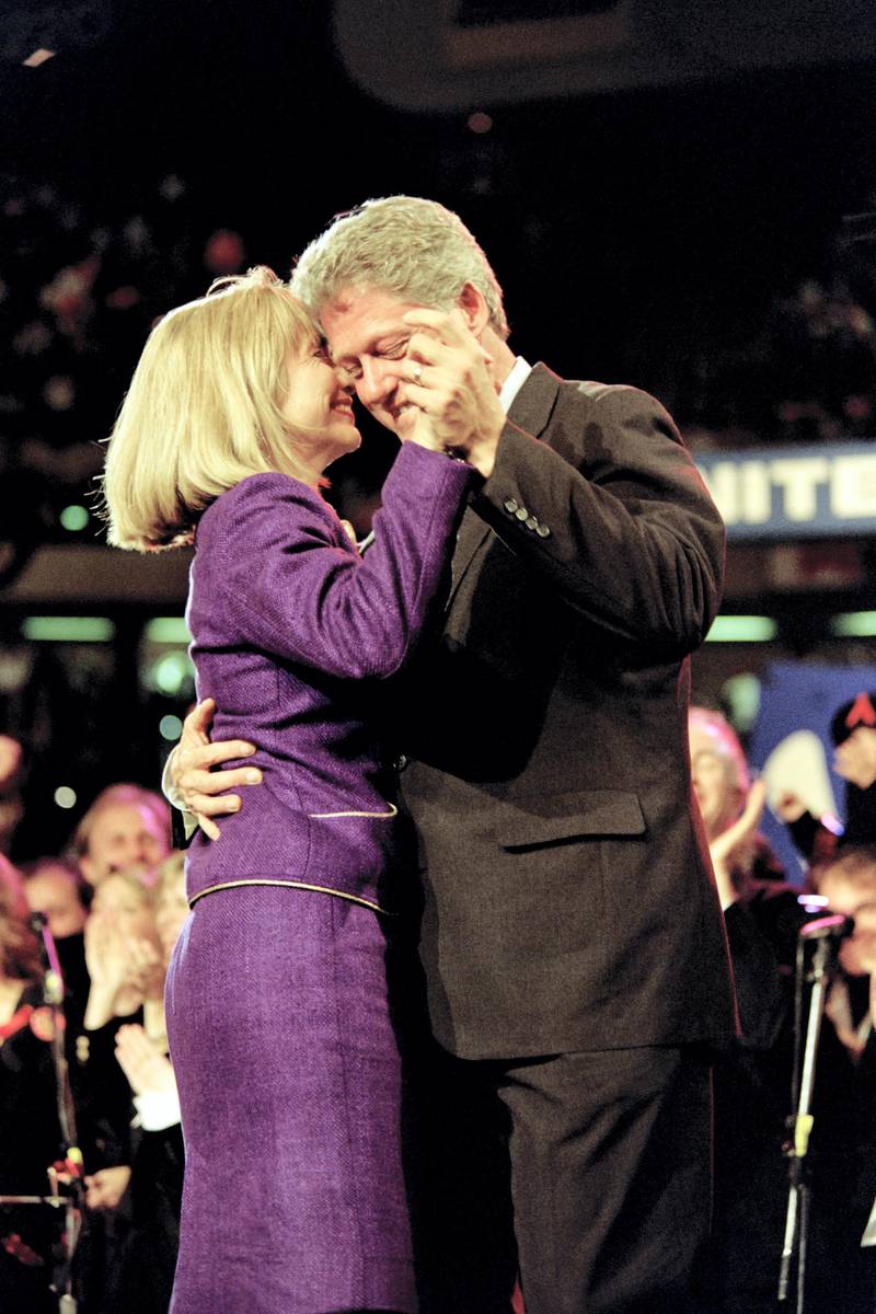 Democratic presidential candidate Bill Clinton dances with his wife Hillary (L) at a rally on November 1, 1992 in East Rutherford. - The event was simulcast via satellite to four other cities. (Photo by Timothy A. CLARY / AFP)