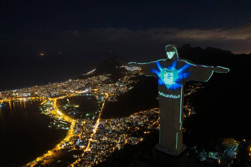 The iconic Christ the Redeemer statue is lit up as if wearing a protective mask and with a slogan that reads in Portuguese: "Mask saves," in Rio de Janeiro, Brazil, on May 3, 2020. AP Photo