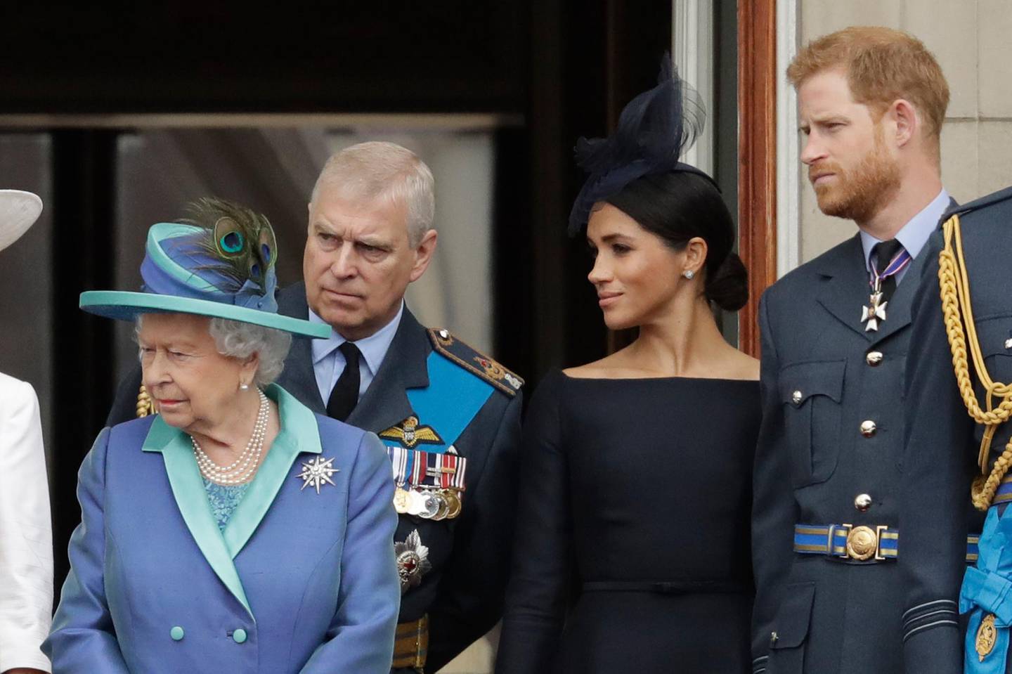 FILE - In this Tuesday, July 10, 2018 file photo Britain's Queen Elizabeth II, Prince Andrew, Meghan the Duchess of Sussex and Prince Harry stand on a balcony to watch a flypast of Royal Air Force aircraft pass over Buckingham Palace in London. As part of a surprise announcement distancing themselves from the British royal family, Prince Harry and his wife Meghan declared they will "work to become financially independent" _ a move that has not been clearly spelled out and could be fraught with obstacles. (AP Photo/Matt Dunham, File)