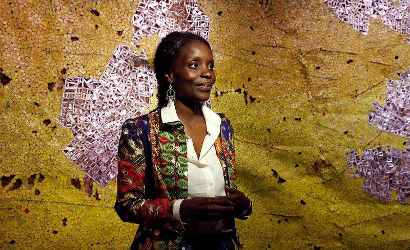 Ghana pavilion curator Nana Oforiatta Ayim smiles during the 58th Biennale of Arts exhibition in Venice, Italy, Tuesday, May 7, 2019. Political issues that excite newsprint, airwaves and social media, such as fake news, migration, poverty, global warming and armed conflict, are getting a very open airing at the 58th Venice Biennale contemporary art fair, which Saturday, May 11, and runs through Nov. 24, 2019.  (AP Photo/Antonio Calanni)