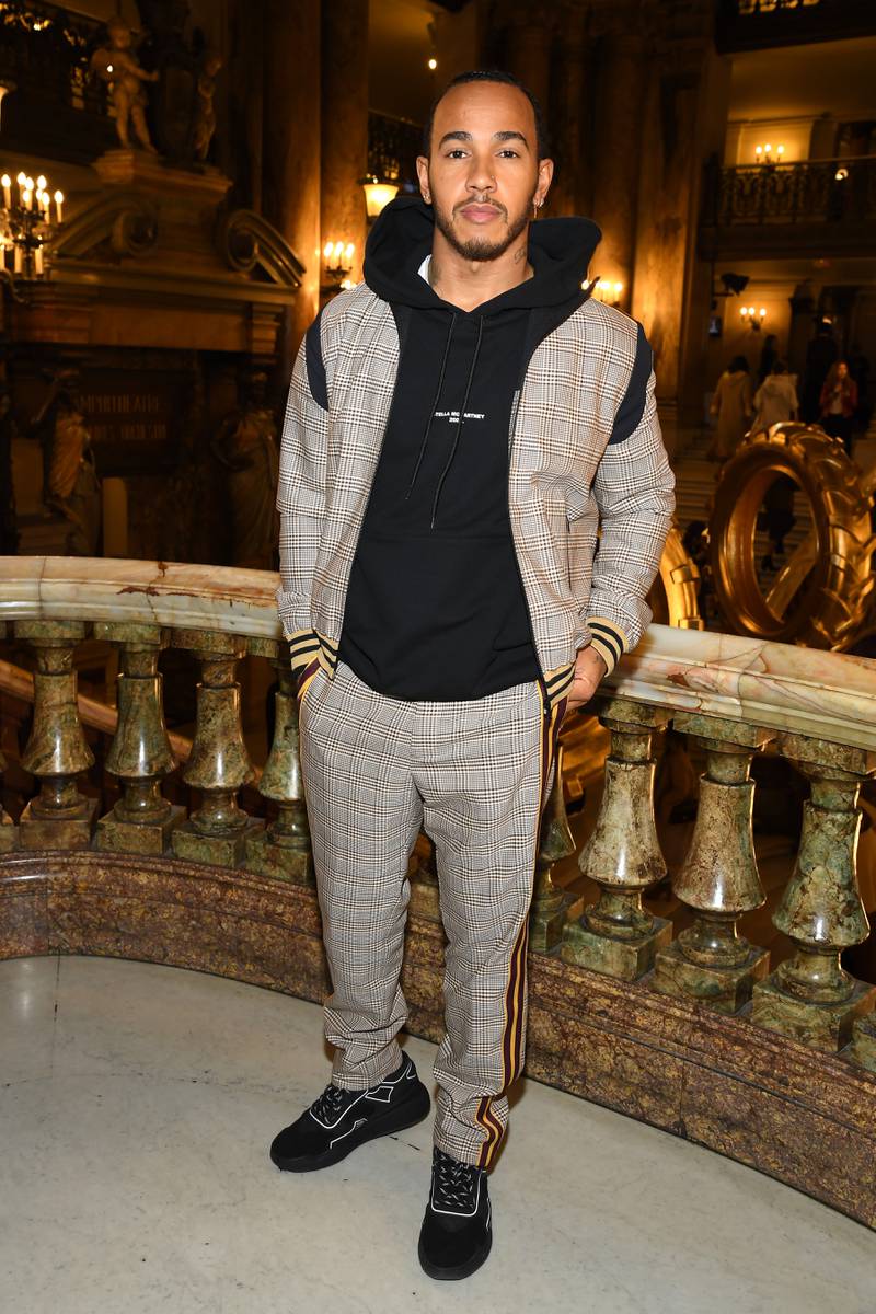 Lewis Hamilton, in an a brown chequered tracksuit by Stella McCartney, attends the Stella McCartney show as part of Paris Fashion Week on March 04, 2019. Getty Images