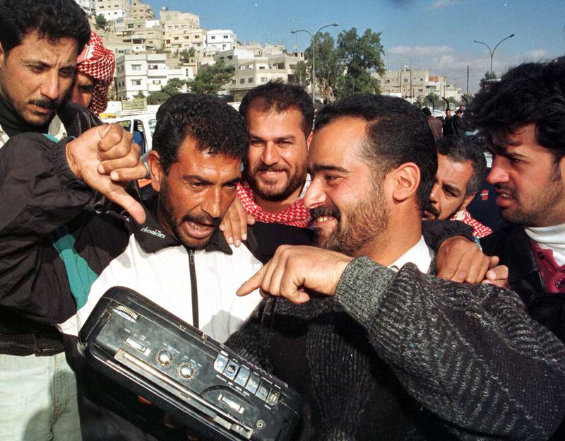 Iraqis living in Amman listen the news of the latest situation in their homeland in December 1998. Reuters