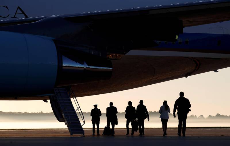 On a misty morning, members of the White House press corps board Air Force One at Joint Base Andrews in Maryland, US, on their way to Las Vegas with US President Donald Trump. Kevin Lamarque / Reuters