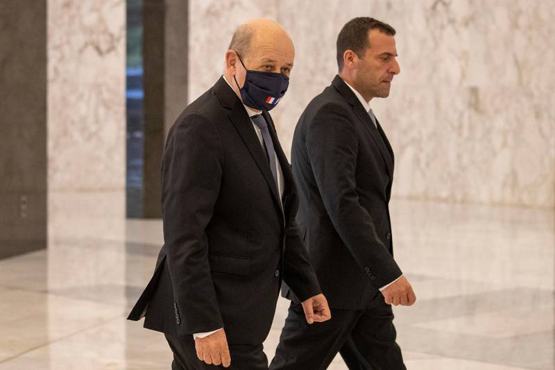 French Foreign Minister Jean-Yves Le Drian wears a face mask as he arrives at Baabda Palace to meet Lebanon’s President Michel Aoun. Reuters