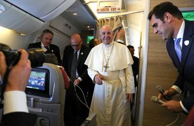 Pope Francis arrives to speak to reporters aboard a plane on the way to Abu Dhabi February 3, 2019. REUTERS/Tony Gentile/Pool