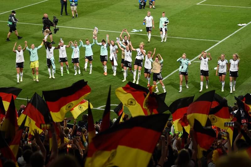 Germany celebrate their win in front of their fans after the final whistle. Getty