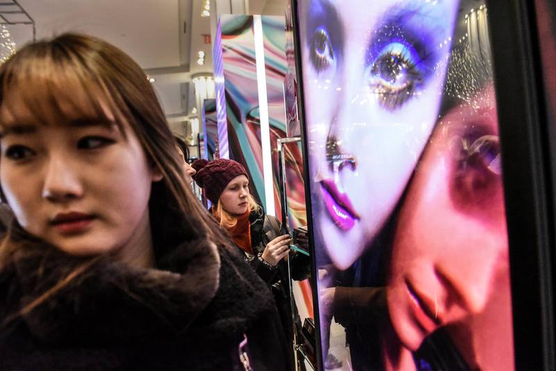 People shop for cosmetics at Macy's. Reuters