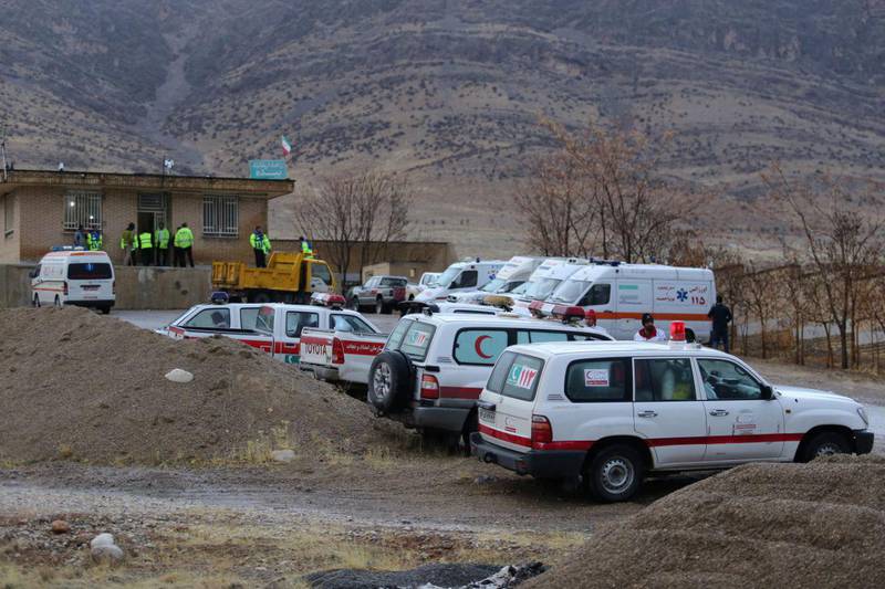 Ambulances and vehicles are seen following a plane crash near the town of Semirom, Iran. Tasnim News Agency / Reuters