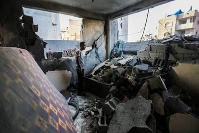 Khan Younis residents search through buildings destroyed during Israeli air raids. Getty Images