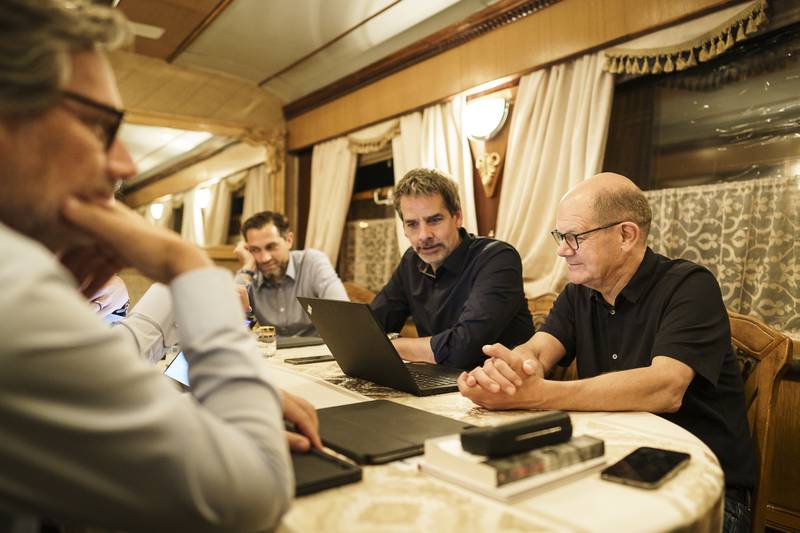 Mr Scholz (R) on a night train to Kyiv. Getty Images