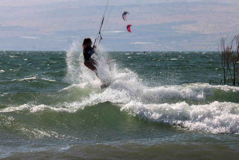 A girl kite surfs in the Sea of Galilee. AFP
