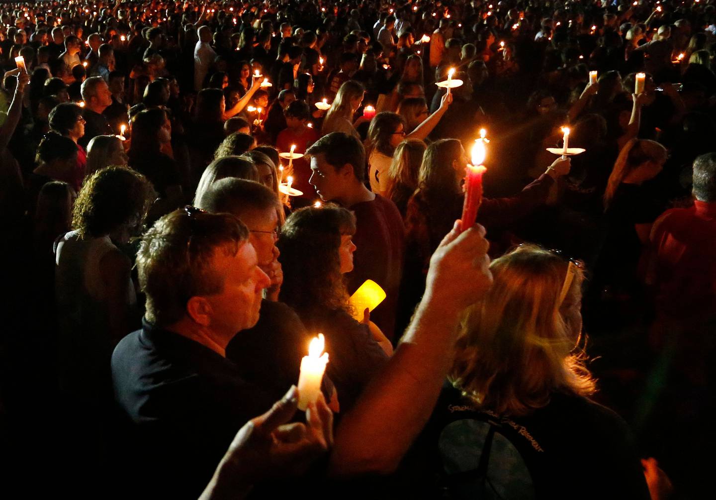Thousands of mourners hold candles during a candlelight vigil for the victims of Marjory Stoneman Douglas High School shooting in Parkland, Florida on October 15, 2018. AFP