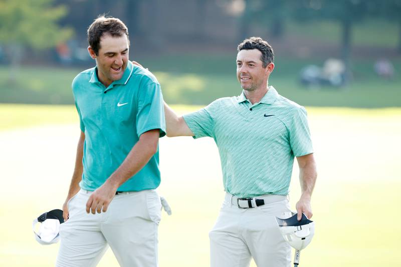 Scottie Scheffler congratulates Rory McIlroy on the 18th green after McIlroy won on Sunday. AFP