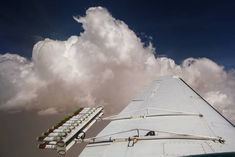 Hygroscopic salt flares are attached to an aircraft during a cloud-seeding flight between Al Ain and Al Hayer. At 9,000 feet above sea level, the plane releases the flares into the most promising white clouds, hoping to trigger rainfall.