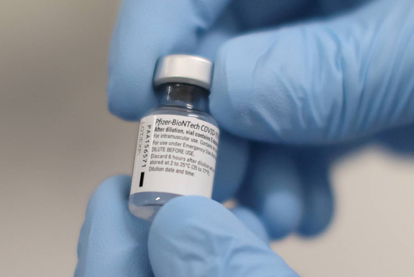 FILE PHOTO: A vial of the Pfizer/BioNTech COVID-19 vaccine is seen ahead of being administered at the Royal Victoria Hospital  in Belfast, Northern Ireland December 8, 2020. Liam McBurney/Pool via REUTERS/File Photo