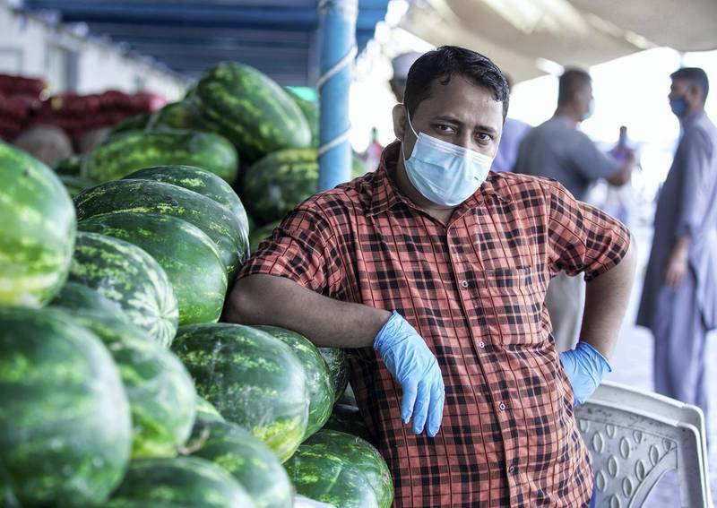 Abu Dhabi, United Arab Emirates, April 14, 2020.  A fruit vendor with his watermelons at the Abu Dhabi Fruits and Vegetables Market during the Coronavirus epidemic.  Victor Besa / The NationalSection:  NA