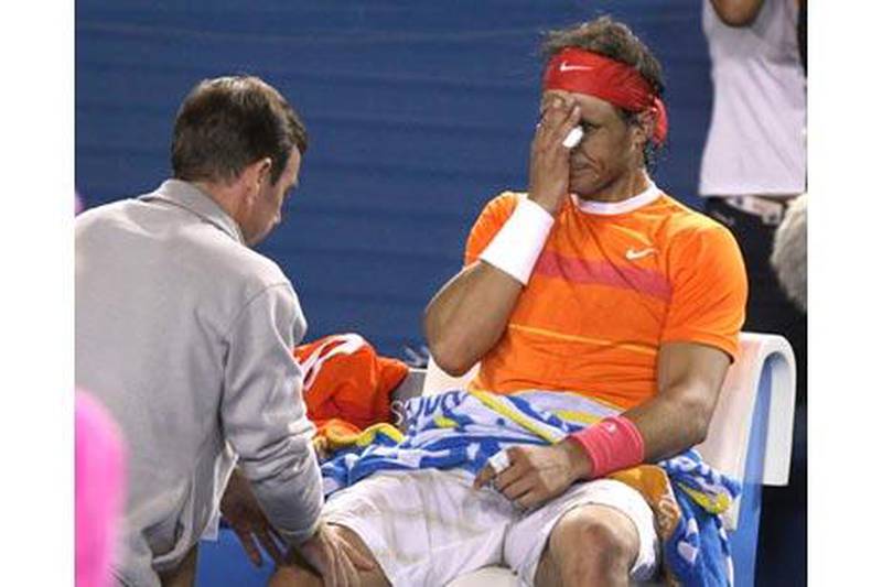 Rafael Nadal receives medical treatment during the third set against Andy Murray. The Spaniard was forced to retire from the Australian Open.