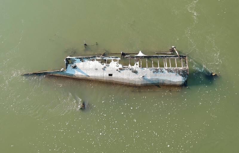 The wreck of a ship that sunk during the Second World War is revealed by the unusually low water level of the Danube near Vamosszabadi, north-western Hungary. EPA 
