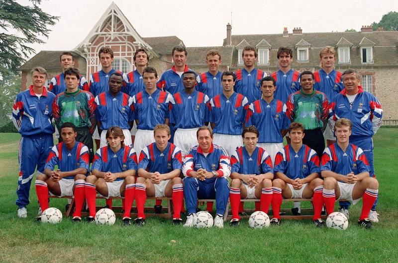 In this file photo taken on August 19, 1993 France's national football team players pose for the official family photo in Clairefontaine (Top from left) Alain Roche, Jean-Luc Dogon, David Ginola, coach Philippe Bergeroo, Franck Sauzee, Laurent Blanc, Eric Cantona and Emmanuel Petit; (second row from left) head coach Aime Jacquet, Bruno Martini, Basile Boli, Paul Le Guen, Marcel Desailly, Jean Michel Ferri, Pascal Vahirua, Bernard Lama, Henri Emile; (bottom from left) Franck Sylvestre, Reynald Pedros, Jean-Pierre Papin, coach Gerard Houllier, Corentin Martins, Bixente Lizarazu and Didier Deschamps. AFP