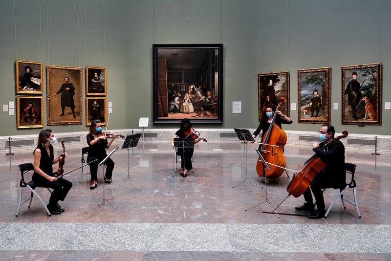 Musicians perform next to Spanish artist Diego Velazquez's paintings as the Prado museum reopens in Madrid, Spain. Reuters