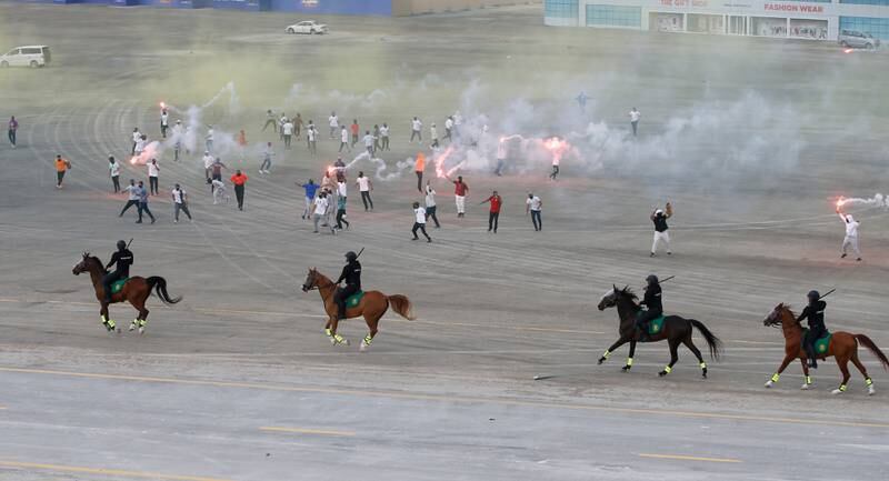 Police on horseback control a mock riot during the show. EPA