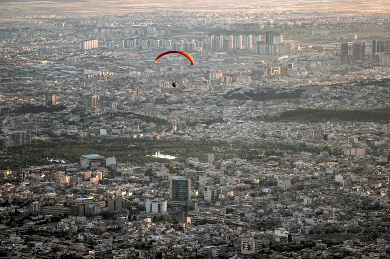 Members of the Sulaymaniyah paragliding team launch at sunset from Mount Azmar to glide over the city of Sulaymaniyah in north-eastern Iraq's autonomous Kurdistan region.