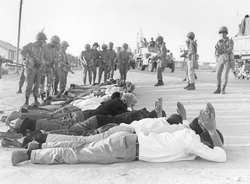 Palestinians surrender to Israeli soldiers in June 1967 in the occupied territory of the West Bank.  On 05 June 1967, Israel launched preemptive attacks against Egypt and Syria. In just six days, Israel occupied the Gaza Strip and the Sinai peninsula of Egypt, the Golan Heights of Syria, and the West Bank and Arab sector of East Jerusalem (both under Jordanian rule), thereby giving the conflict the name of the Six-Day War. (Photo by PIERRE GUILLAUD / AFP)