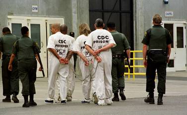 FILE — In this Oct.  28, 1999, file photo a group of inmates is moved from one cell unit to another at California State Prison Sacramento, in Folsom, Calif.  California prison guard Sgt.  Kevin Steele, 56, killed himself after reporting corruption and harassment at the prison to authorities and cooperating with attorneys suing the state according to the Sacramento Bee, Wednesday, Oct.  6, 2021.  (AP Photo / Rich Pedroncelli, File)