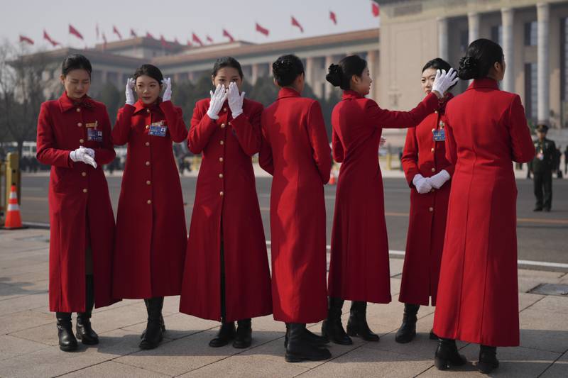 Bus staff gather outside the Great Hall of the People before the opening session of the annual meeting of China's National People's Congress in Beijing. AP

