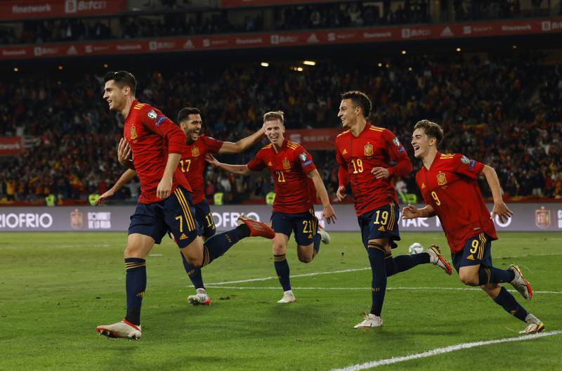 Spain's Alvaro Morata celebrates scoring their first goal with teammates. Reuters