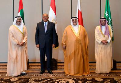 In this Sunday, July 30, 2017 photo released by Bahrain News Agency, from left to right, Foreign Ministers of UAE Abdullah bin Zayed al-Nahyan, Egypt's Sameh Shoukry, Bahrain's Khalid bin Ahmed al-Khalifa and Saudi's Adel al-Jubeir, pose for a photo during their meeting in Manama, Bahrain. Four Arab states that cut ties with Qatar met Sunday to discuss the diplomatic crisis, insisting on compliance with a list of sweeping demands while refraining for now from imposing more punitive measures against the Gulf state. (Bahrain News Agency via AP)