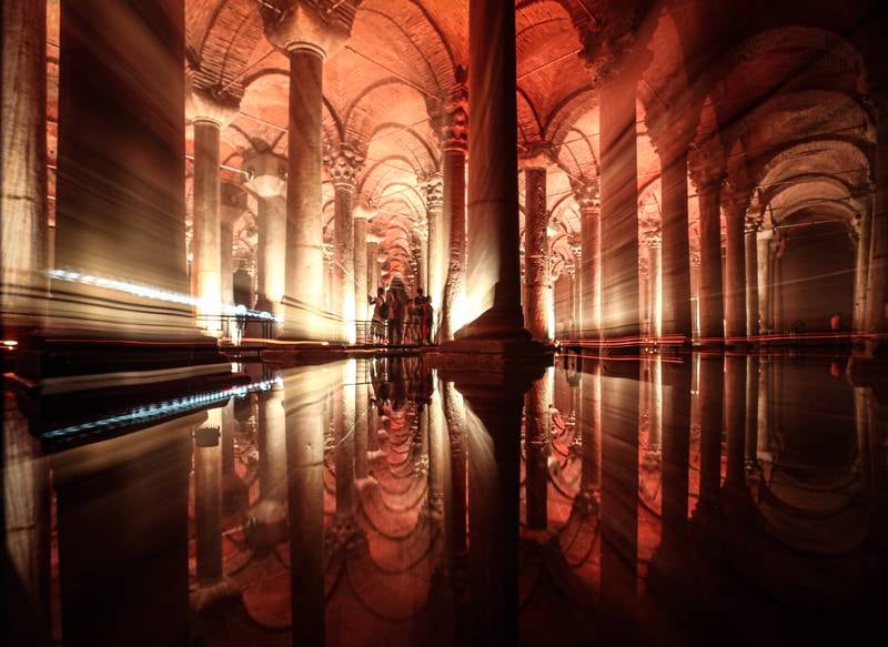 People are reflected in the waters of the Basilica Cistern while visiting the historic site in the Turkish city. 