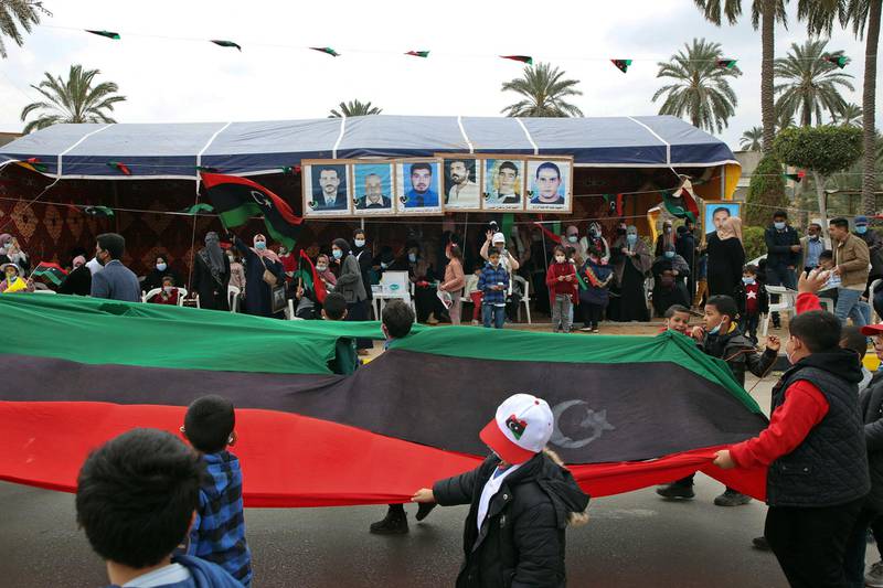 Children march past a crowd in Tripoli. AFP
