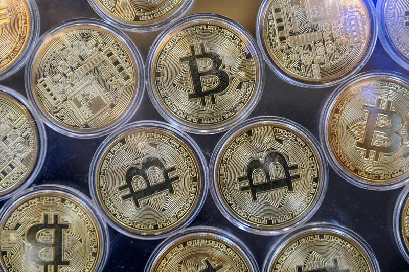 Physical imitation of Bitcoins are pictured at a cryptocurrency exchange branch near the Grand Bazaar in Istanbul on October 20, 2021, a day after Bitcoin took another step closer to mainstream investing with the launch of a new security on Wall Street tied to futures of the cryptocurrency. AFP