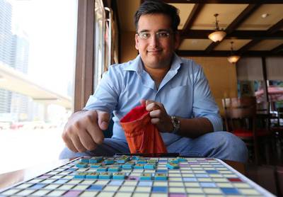 Nikhil Soneja is a champion and head of the UAE Scrabble Club and, as in this cafe in Dubai, is rarely without his board and tiles. He is keen to get more people playing the word game, including an Arabic version. Pawan Singh / The National 