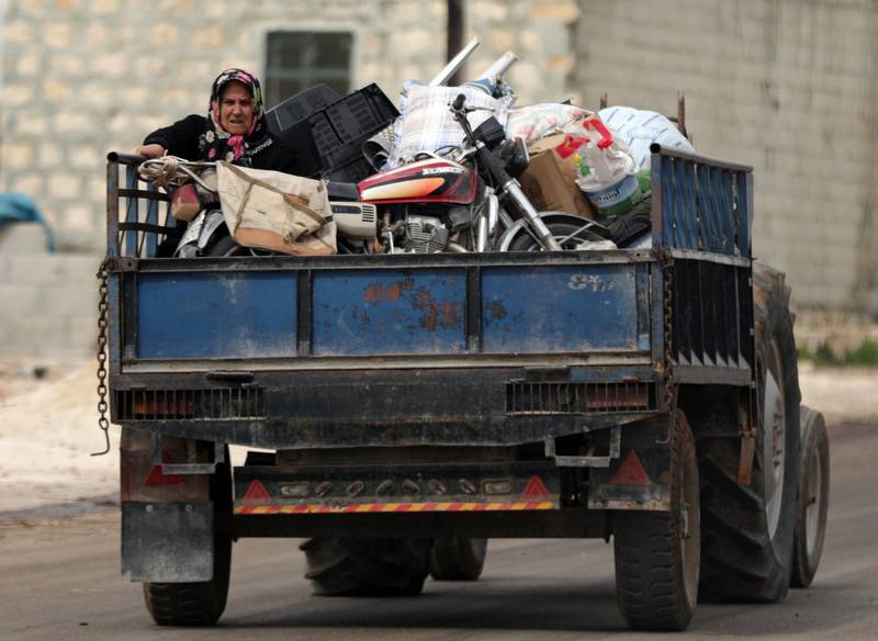 A woman sits on a truck with her belongings after Turkish-backed Free Syrian Army fighters captured Khaldieh village, in eastern Afrin, Syria on March 10, 2018. Khalil Ashawi / Reuters