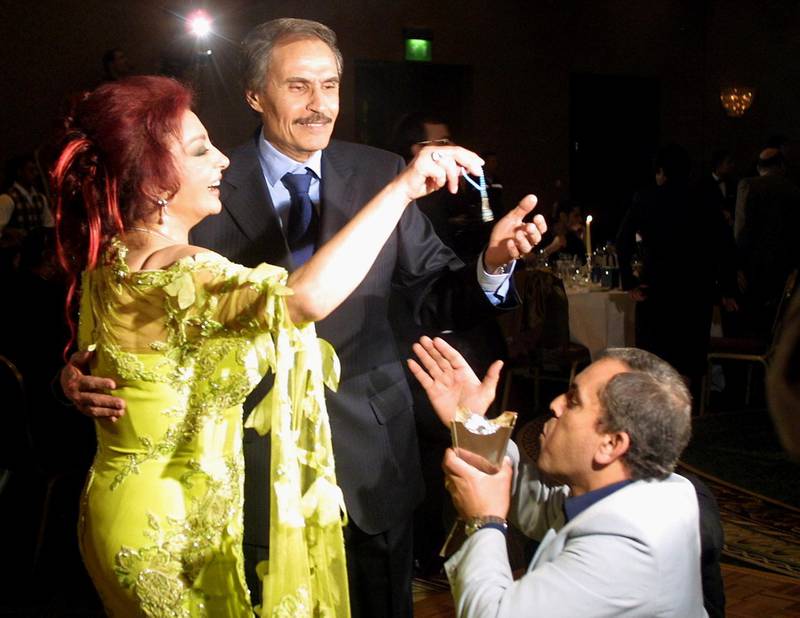 Egyptian actress Nabila Obeid dances with actor Ezzat al-Alayli during her birthday party 09 February 2002 at a five-star hotel in Cairo. Scores of Egyptian and Arab celebrities attended Obeid's party, which became an annual tradition among film stars of the Egyptian capital.       AFPPHPOTO/AMRO MARAGHI (Photo by AMRO MARAGHI / AFP)